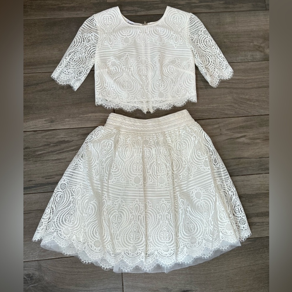 Bebe White two piece crop top with skirt.